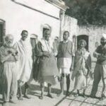 Swami Sivananda walking with devotees discussing mind control
