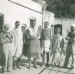 Swami Sivananda walking with devotees discussing mind control