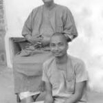 Sri Swami Sivananda with disciple in a historic black and white spiritual photograph
