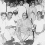 Swami Sivananda with devotees during spiritual gathering