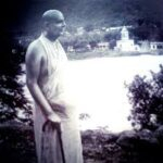 Swami Sivananda overlooking peaceful riverside landscape