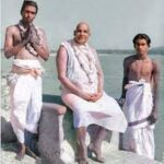 Swami Sivananda with disciples beside sacred river