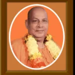 Swami Sivananda portrait with flower garland and peaceful expression