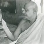 Swami Sivananda reading spiritual text thoughtfully