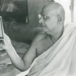 Swami Sivananda reading spiritual text thoughtfully