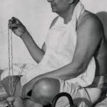Swami Sivananda chanting mantra with sacred prayer beads