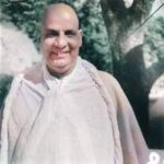 Smiling Swami Sivananda outdoors inspiring spiritual seekers