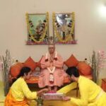 Devotees performing Guru worship before spiritual master