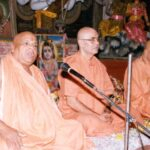 Bhakti Yoga spiritual teachers delivering devotional discourse inside sacred temple together
