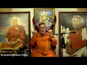 Spiritual teacher delivering discourse before revered guru portraits with devotion together
