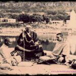 Swami Sivananda teaching devoted disciples beside sacred river