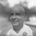 Swami Sivananda smiling portrait in traditional attire