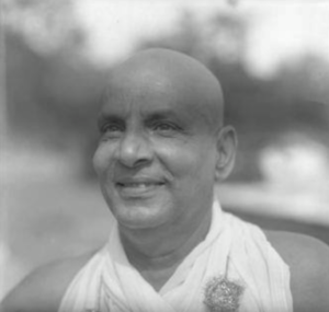 Swami Sivananda smiling portrait in traditional attire