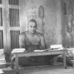 Swami Sivananda studying and writing spiritual teachings