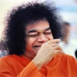 Sri Sathya Sai Baba laughing joyfully with radiant divine expression always