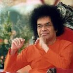Sri Sathya Sai Baba seated peacefully sharing divine love and blessings