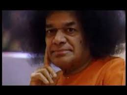 Sri Sathya Sai Baba displaying serene thoughtful divine expression peacefully