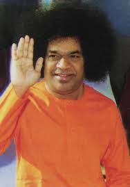 Sri Sathya Sai Baba blessing devotees with smiling divine expression gracefully