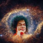 Bhagawan Sri Sathya Sai Baba giving a loving blessing with raised hand