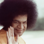 Bhagawan Sri Sathya Sai Baba raising hand in blessing