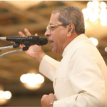Professor Anil Kumar delivering inspiring Sathya Sai Sunday spiritual discourse gracefully