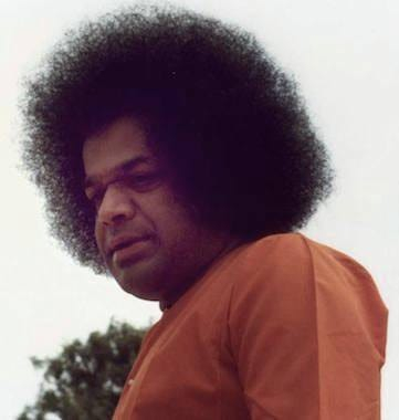 Bhagawan Sri Sathya Sai Baba looking downward in quiet contemplation
