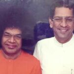 Sri Sathya Sai Baba with translator Anil Kumar smiling together