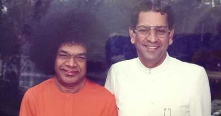 Sri Sathya Sai Baba with translator Anil Kumar smiling together