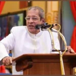 Anil Kumar delivering spiritual discourse at Kulwant Hall podium gracefully