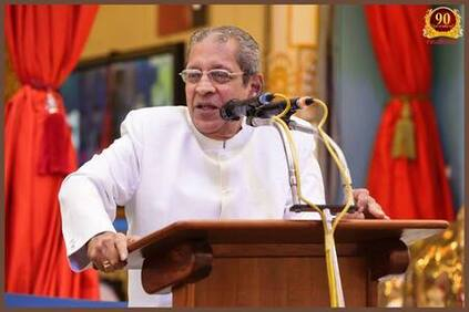 Anil Kumar delivering spiritual discourse at Kulwant Hall podium gracefully